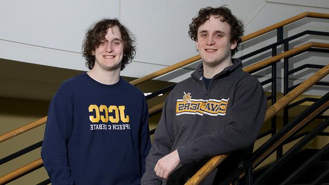 Brothers Travis (on the left) and Thomas (on the right) Babcock pose on stairs.