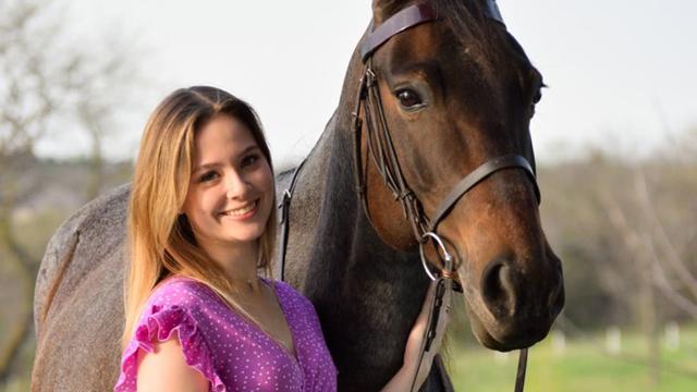 Abby Obertop standing with her horse